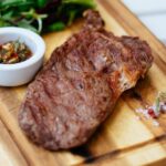 Shallow Focus Photography of Meat Dish and Leaves