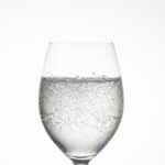 Clear Wine Glass with Liquid on Marble Top