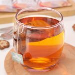 clear drinking glass with orange liquid