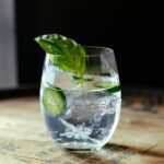 clear drinking glass with green leaf