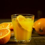 orange juice in clear drinking glass